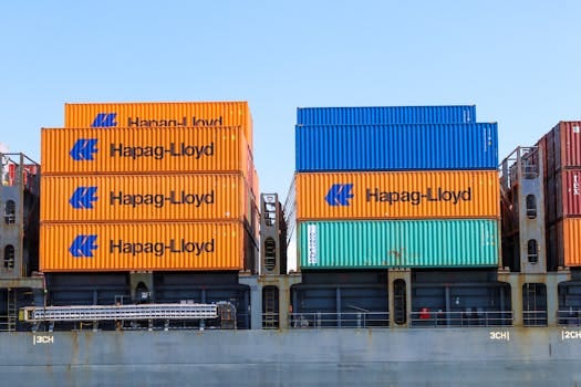 Colorful cargo containers stacked at an industrial port terminal.